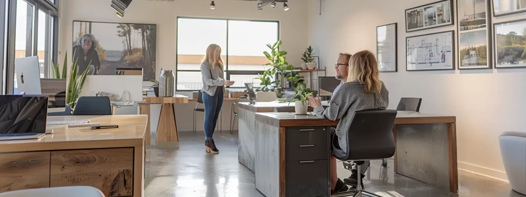a modern office space showcases a focused homeowner engaging in conversations with a water damage restoration professional, surrounded by blueprints and repair estimates, highlighting the meticulous management of post-claim repairs.